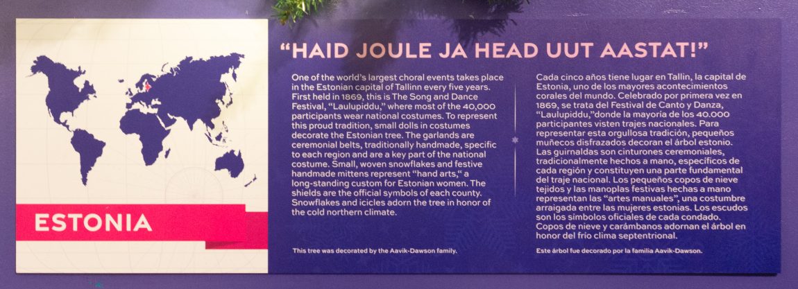 "HAID JOULE JA HEAD UUT AASTAT!"
One of the world's largest choral events takes place in the Estonian capital of Tallinn every five years. First held in 1869, this is The Song and Dance Festival, “Laulupidu,” where most of the 40,000 participants wear national costumes. To represent this proud tradition, small dolls in costumes decorate the Estonian tree. The garlands are ceremonial belts, traditionally handmade, specific to each region and are a key part of the national costume. Small, woven snowflakes and festive handmade mittens represent “hand arts,” a long-standing custom for Estonian women. The shields are the official symbols of each county. Snowflakes and icicles adorn the tree in honor of the cold northern climate.
This tree was decorated by the Aavik-Dawson family.
