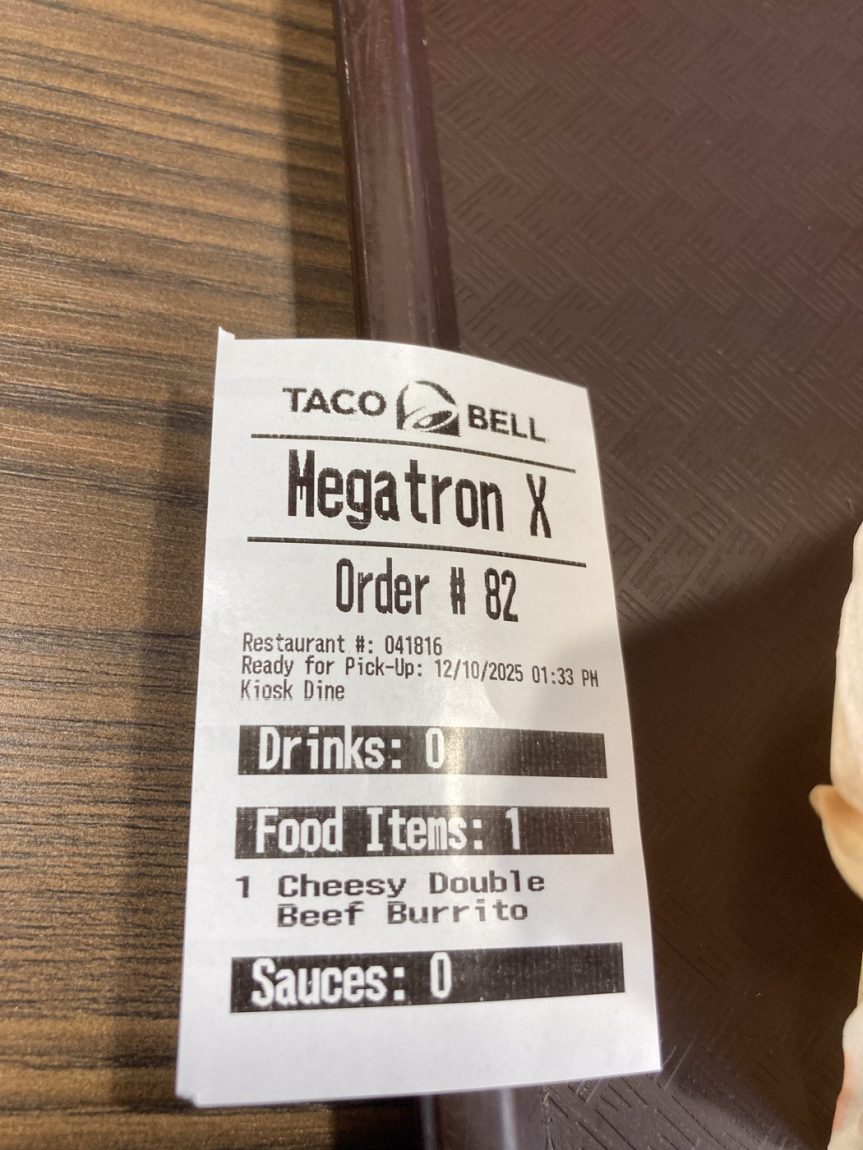 Taco Bell order sticker on tray. It has the name "Megatron X" on the sticker.