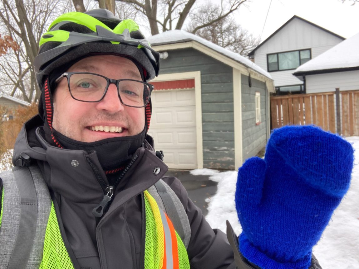 The author standing in Glen Ellyn, Illinois wearing his neon green helmet, neon green vest, and bright blue Cubs mittens.