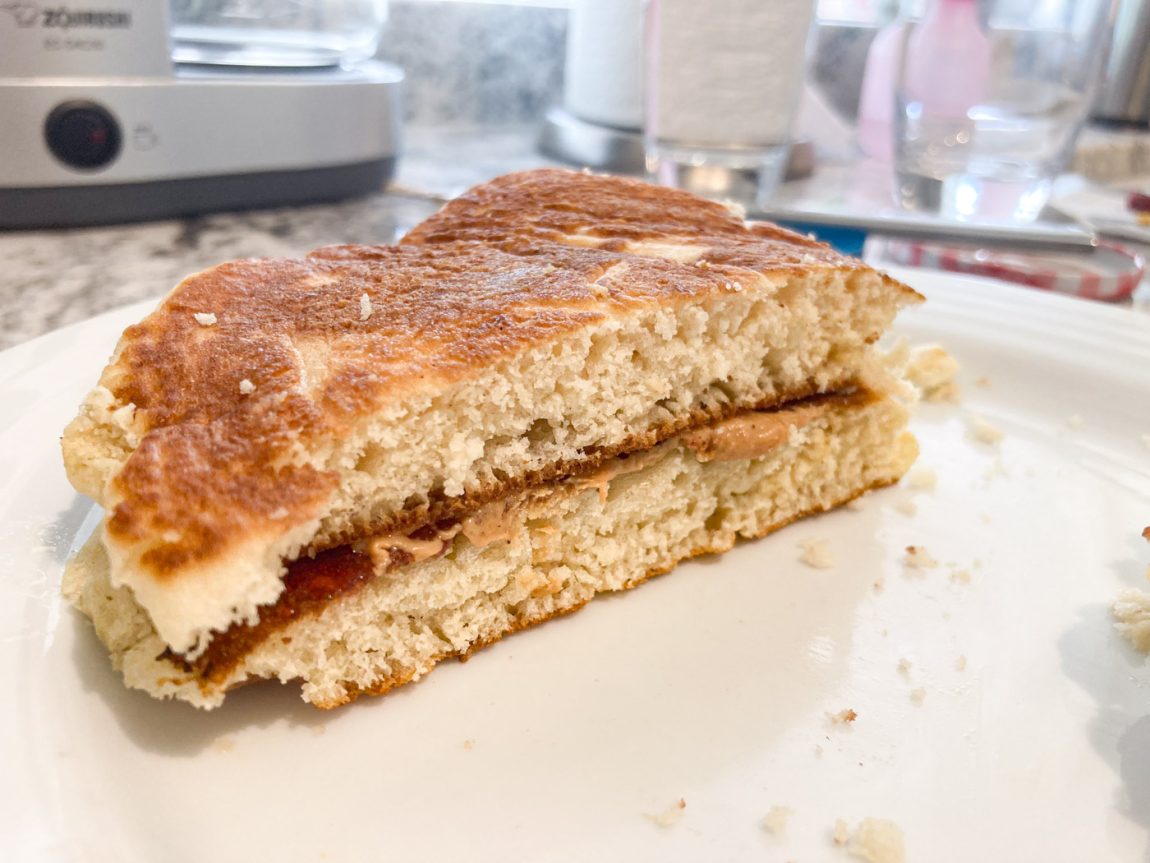 Photo of PB&J sandwich at home, using leftover pancakes. The jelly and peanut butter are spread on light.